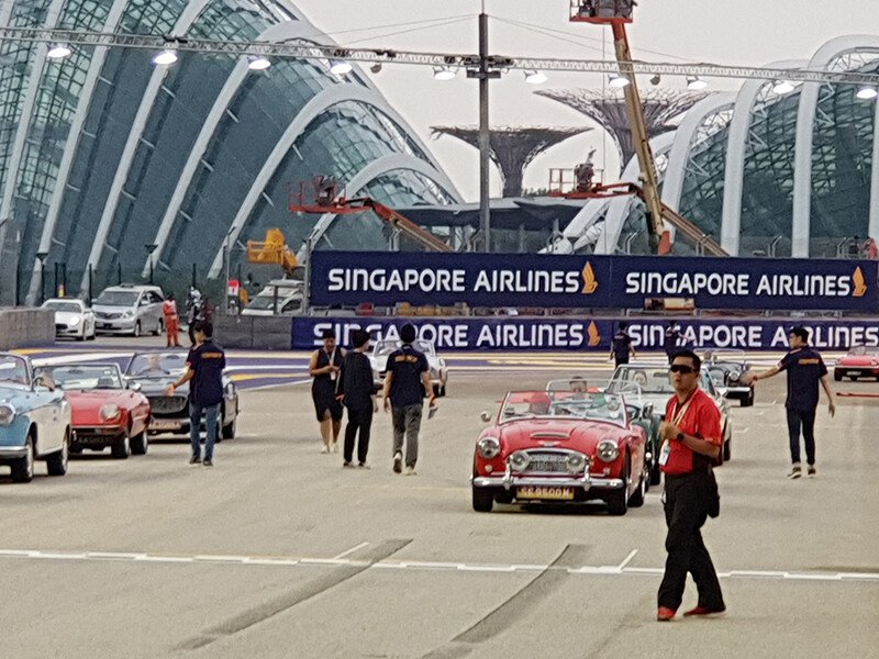 Different vintage sports cars line up on the track