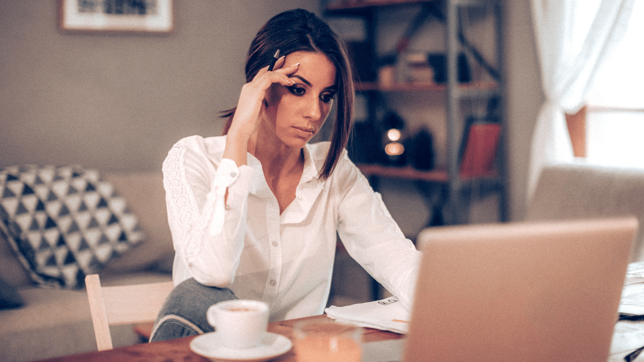 Woman intently analyzing content on her laptop