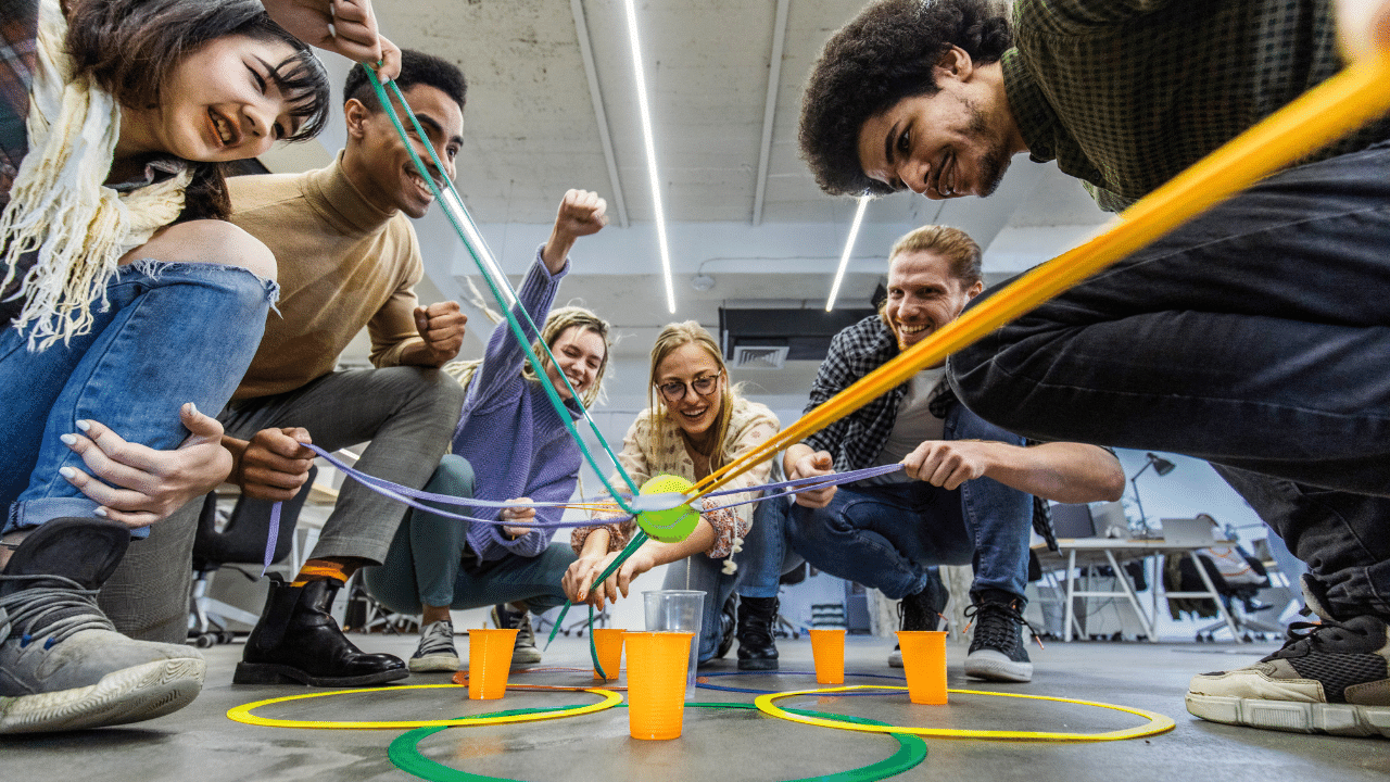 Team doing their best to get the ball inside a plastic cup